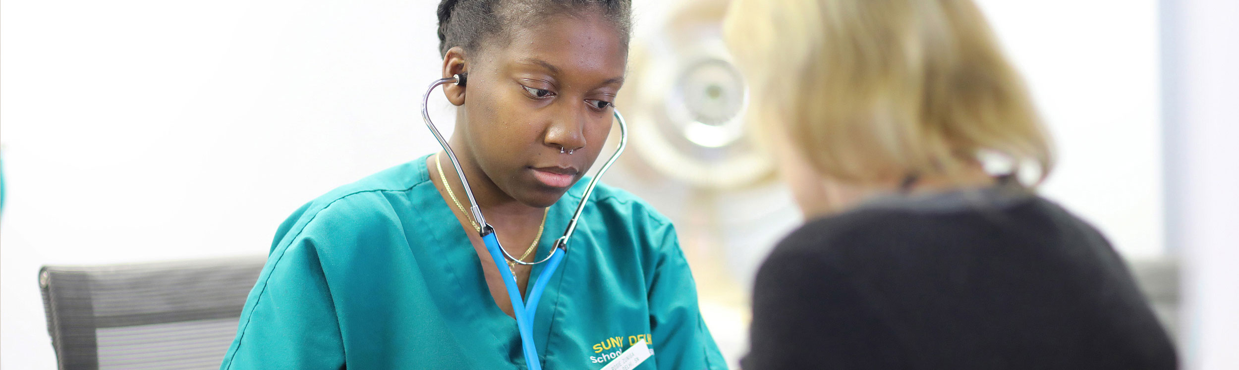 Nursing student consulting patient