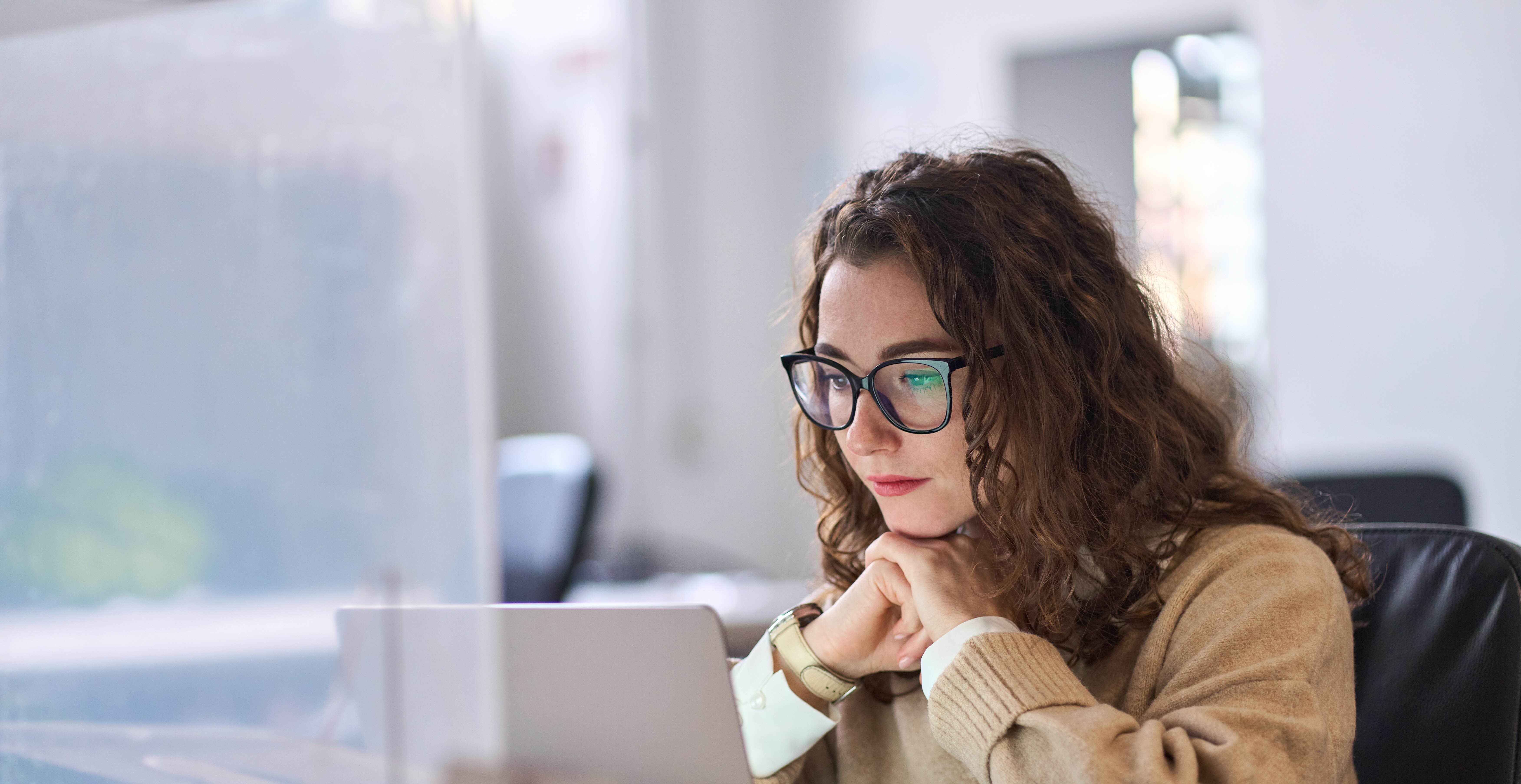 Student at desk looking at computer