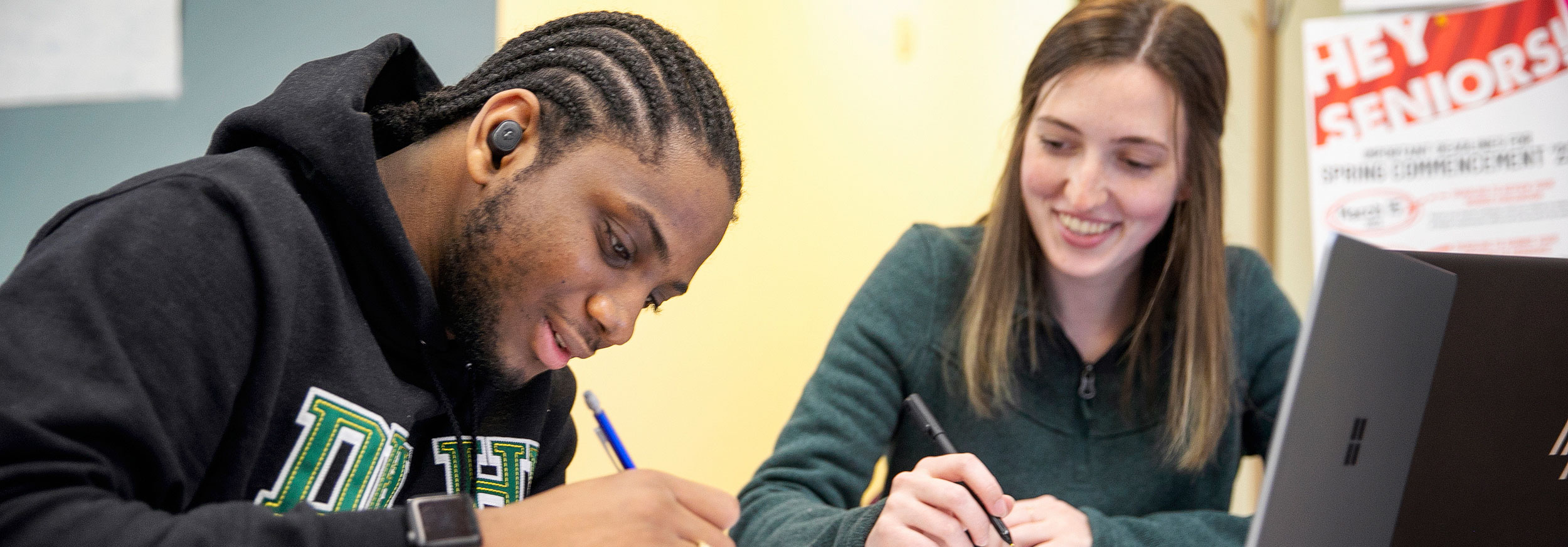 Student getting tutored at desk