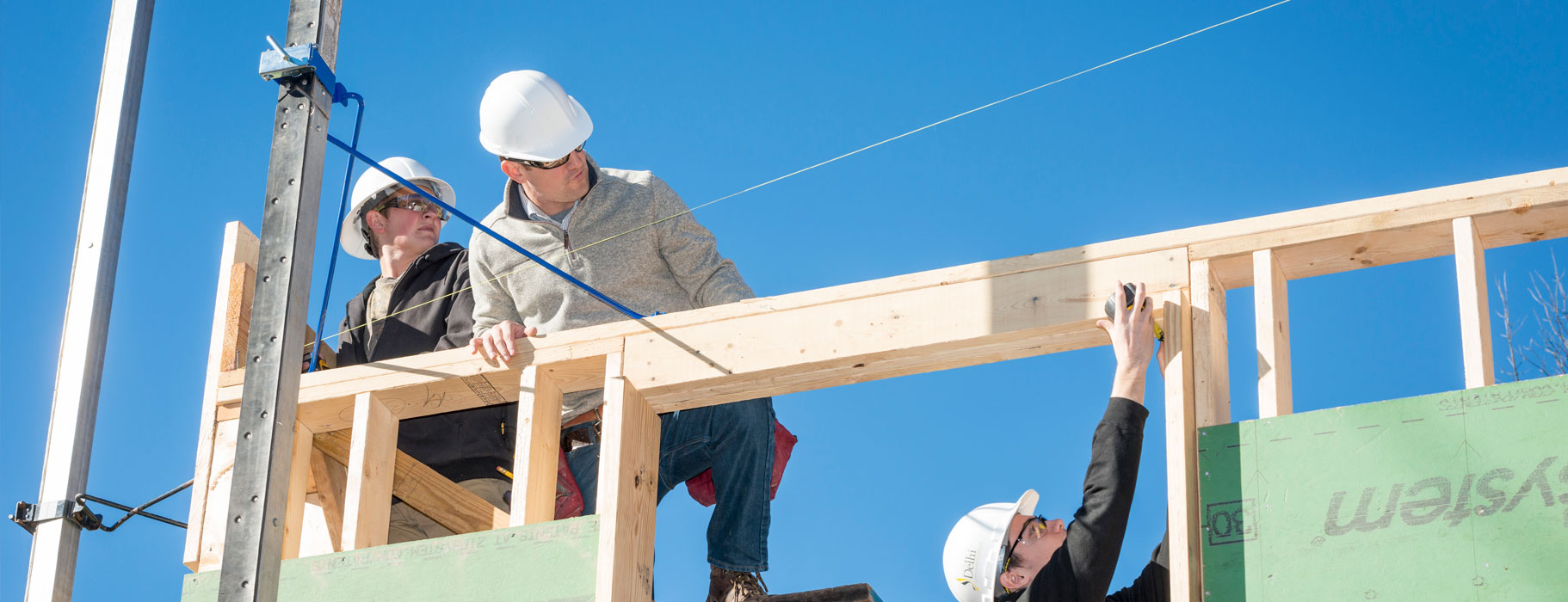 People building a house frame