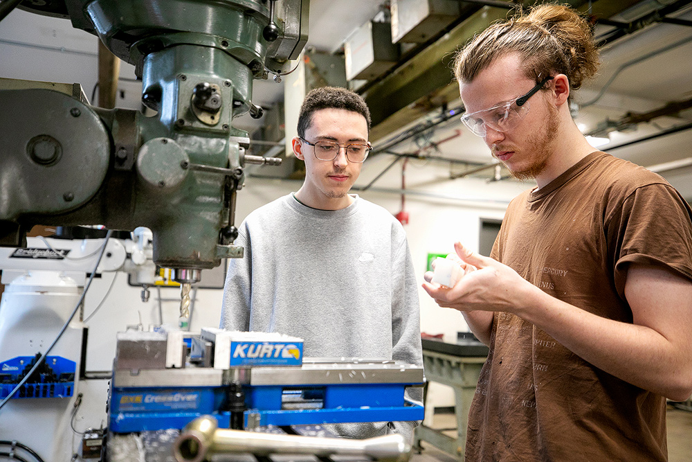 Mechatronics students looking at a dohickie