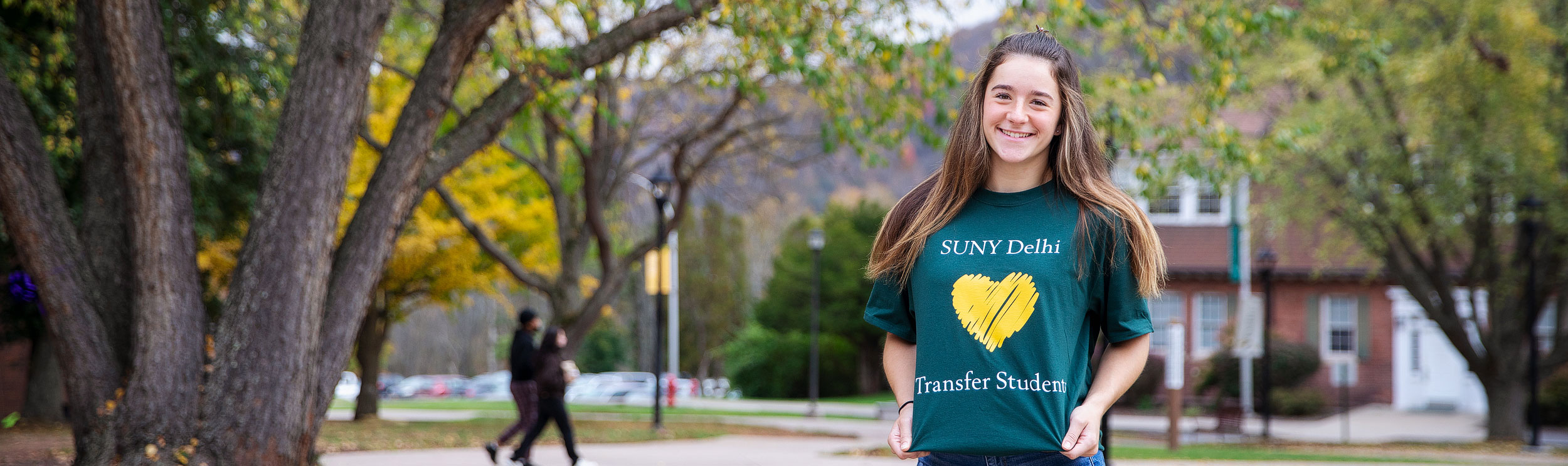 Student in foreground showing shirt