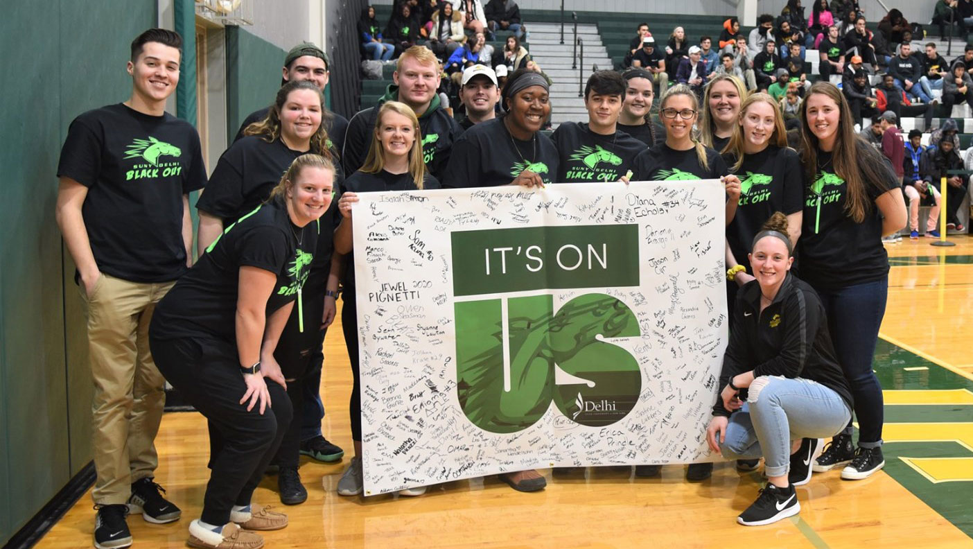 Students holding up "It's On Us" banner